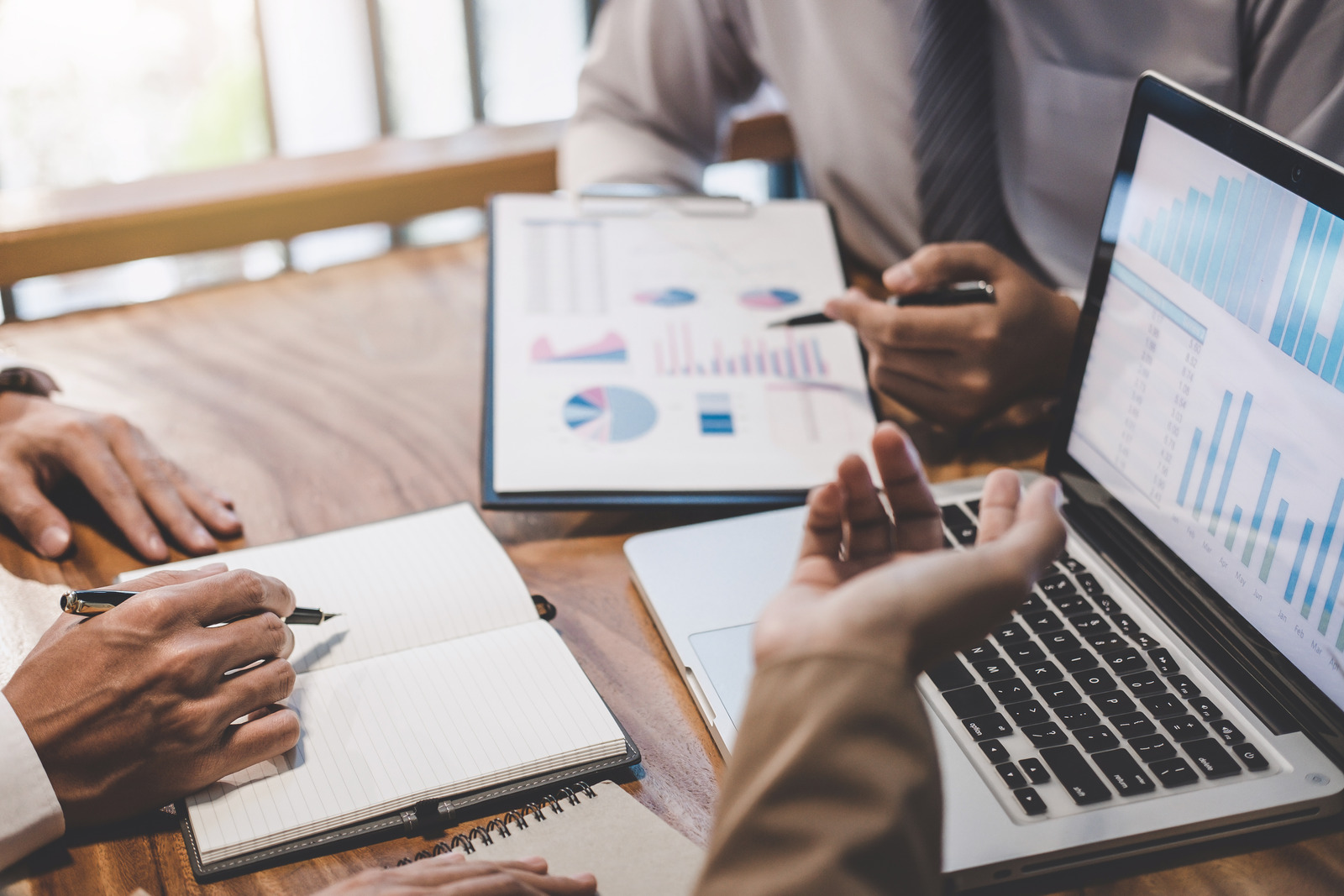 Business team working with new startup project plan and discussion information for financial strategy with laptop and digital tablet in a modern business lounge.